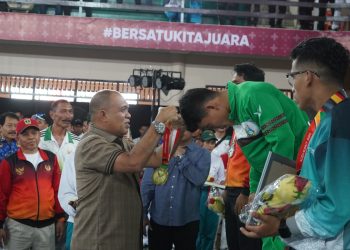 Pj Bupati Langkat Kalungkan Medali kepada Juara Cabang Olahraga Sambo